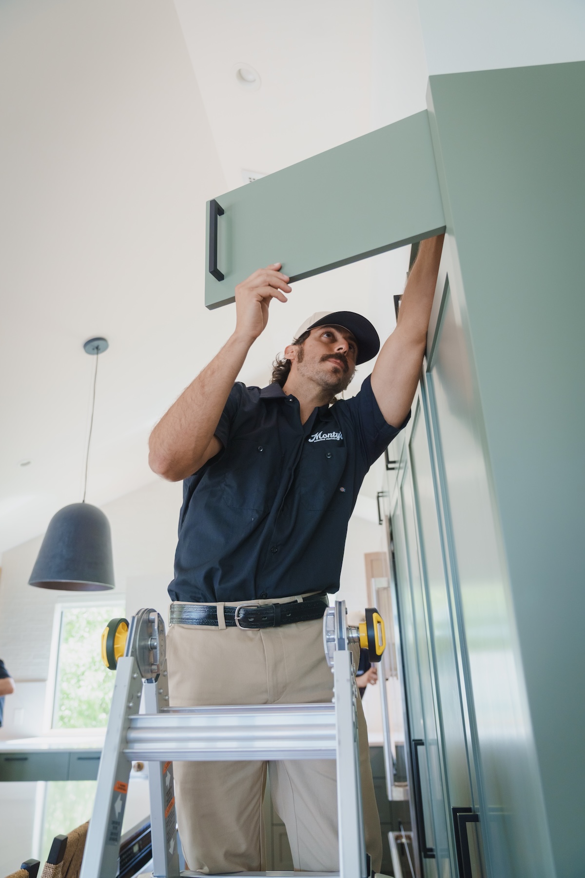 Monty's technician performing preventative cabinet maintenance